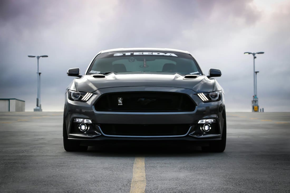 Black muscle car front end after a full detail