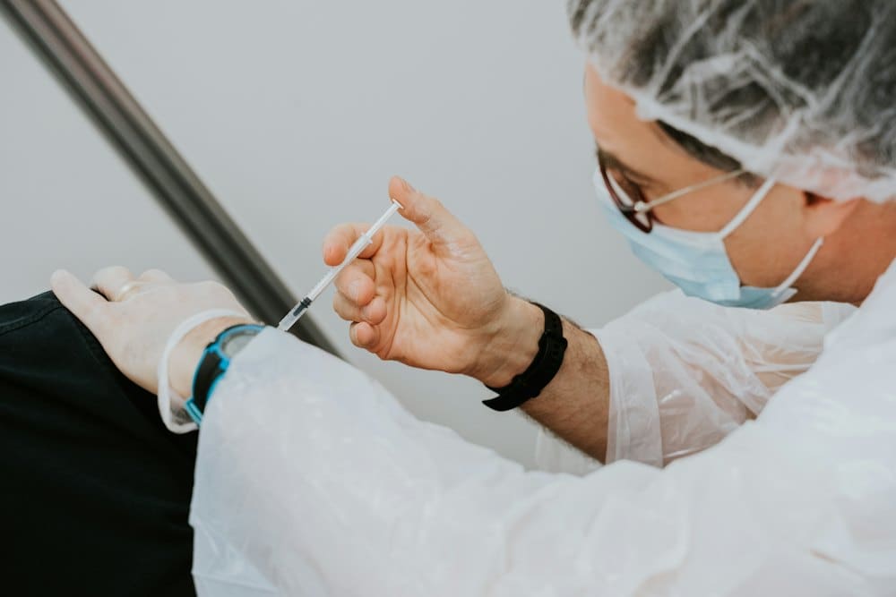 Clinician preparing a vaccination syringe