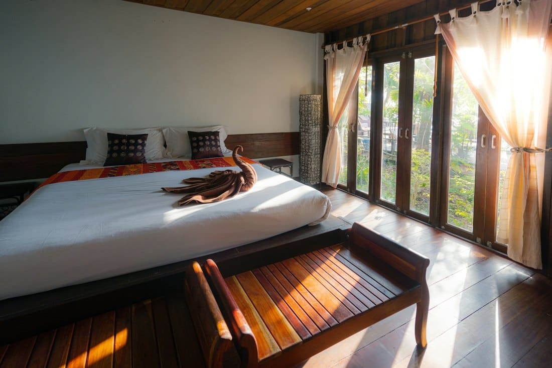 Sunlit deluxe room with king bed and garden-facing French doors