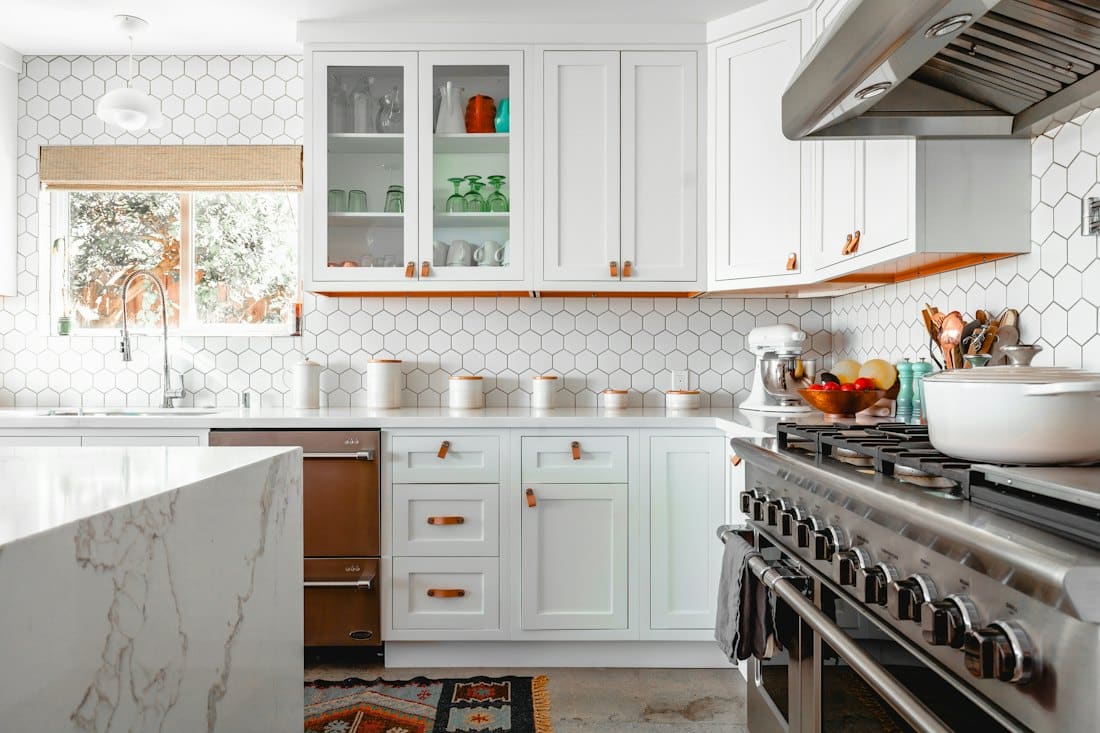 Bright kitchen with hexagon tile splash and range cooker
