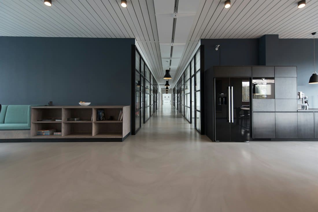 Calm open office corridor with slatted ceiling and storage