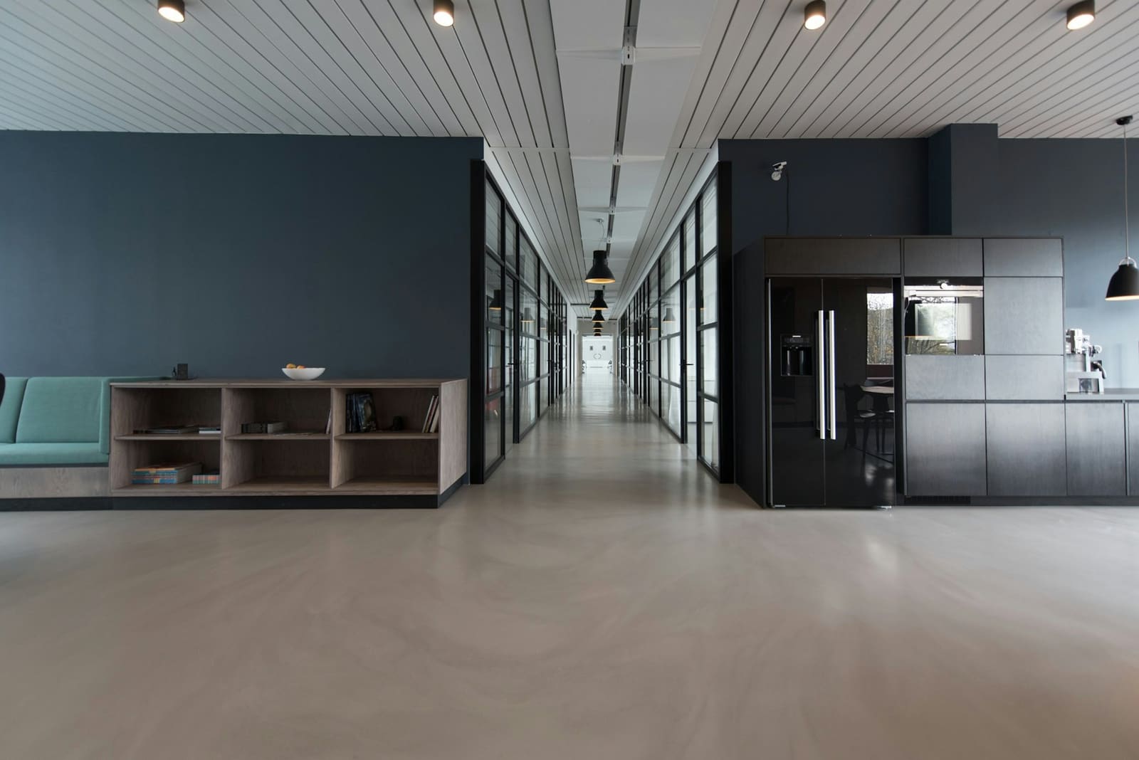 Modern consulting office corridor with glass meeting rooms and polished floors